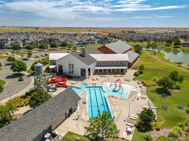 birds eye view of property featuring a water view and a residential view