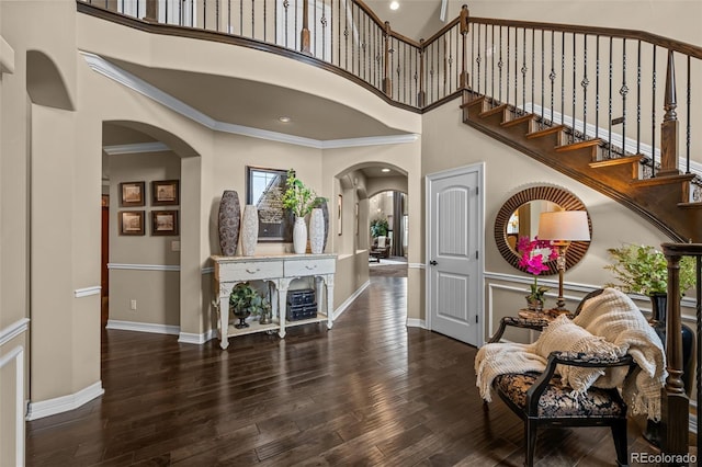 entrance foyer featuring dark wood-type flooring and ornamental molding