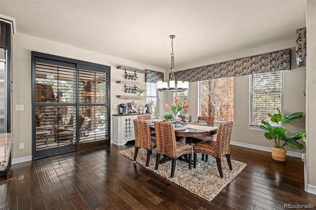 dining room featuring an inviting chandelier and dark hardwood / wood-style floors