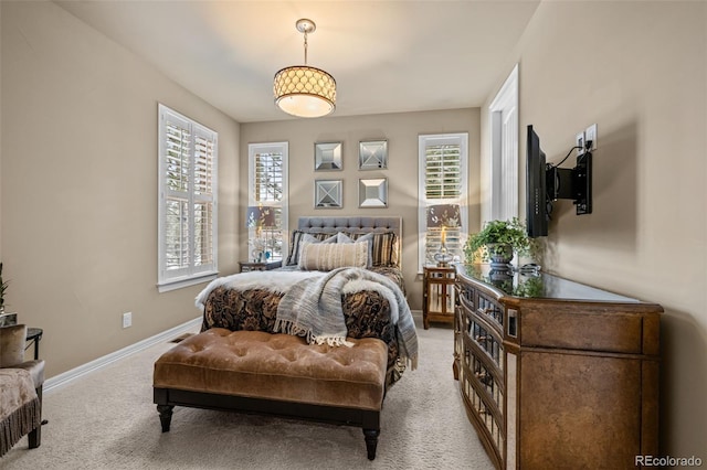 carpeted bedroom with multiple windows