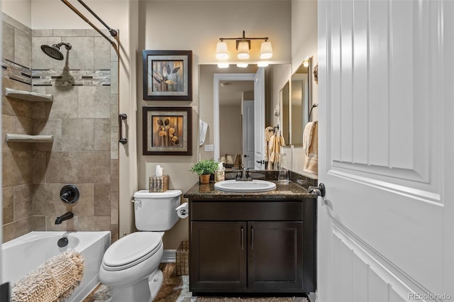 full bathroom with vanity, toilet, and tiled shower / bath