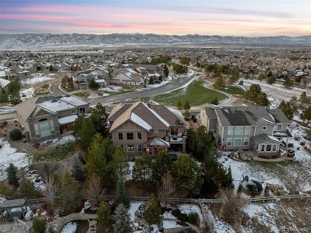 snowy aerial view with a mountain view