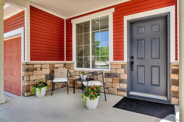 5558 Malta St, Denver, CO 80249 - property entrance with covered porch and stone siding