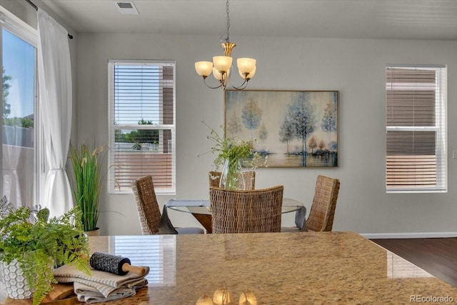 5558 Malta St, Denver, CO 80249 - dining space featuring a chandelier and wood finished floors