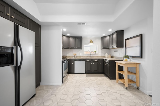 kitchen with visible vents, refrigerator with ice dispenser, dishwashing machine, stainless steel range with electric cooktop, and a sink