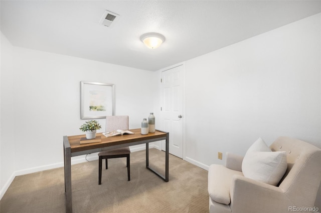 office with visible vents, light colored carpet, and baseboards