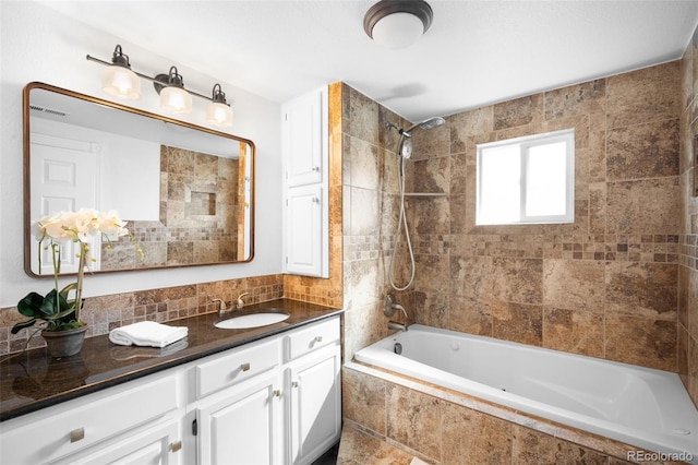 bathroom with vanity and tiled shower / bath combo