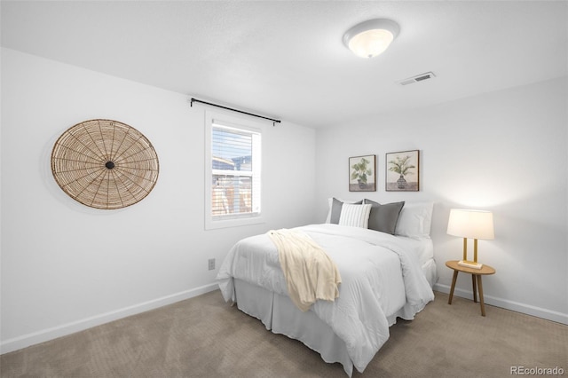 carpeted bedroom featuring visible vents and baseboards