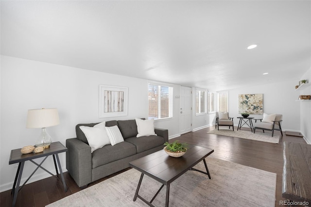 living room with recessed lighting, baseboards, and wood finished floors