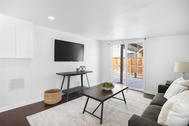 living room with recessed lighting, wood finished floors, visible vents, and baseboards