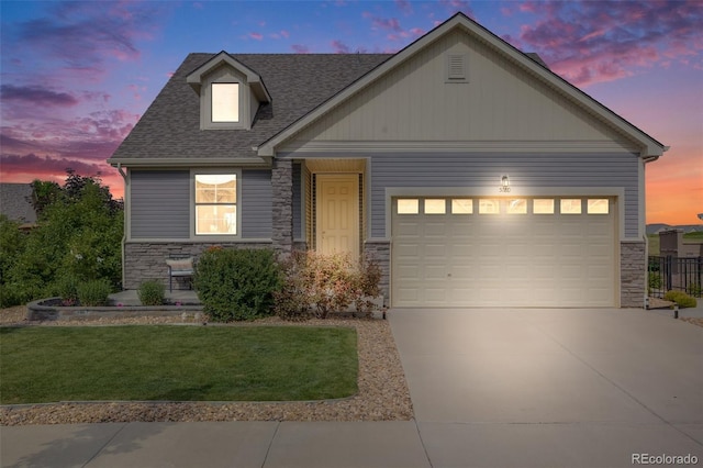 5280 Genoa St, Denver, CO 80249 - craftsman inspired home with stone siding, concrete driveway, an attached garage, a yard, and a shingled roof