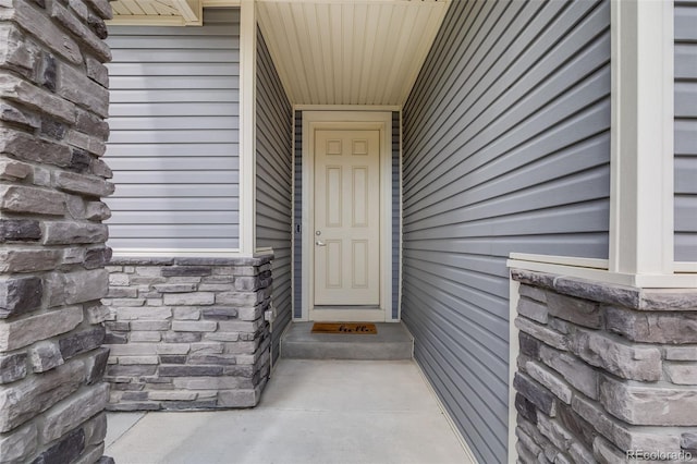 5280 Genoa St, Denver, CO 80249 - doorway to property featuring stone siding