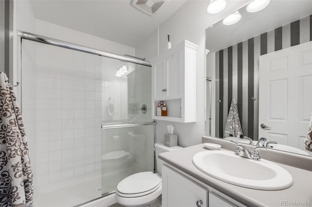 5280 Genoa St, Denver, CO 80249 - full bathroom featuring a stall shower, vanity, and wallpapered walls