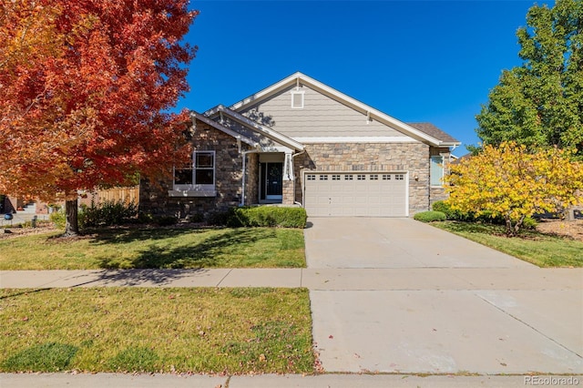 view of front facade with stone siding, a garage, driveway, and a front yard