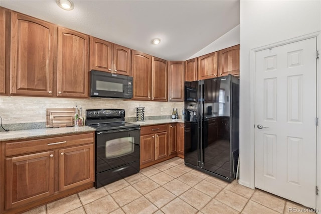 kitchen featuring tasteful backsplash, vaulted ceiling, light tile patterned floors, brown cabinetry, and black appliances