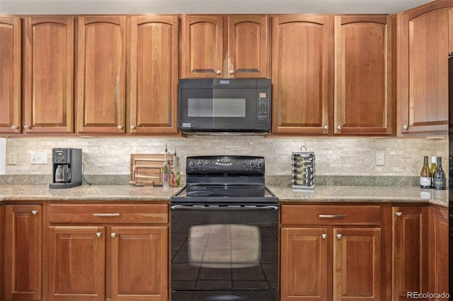 kitchen featuring decorative backsplash, black appliances, and brown cabinets