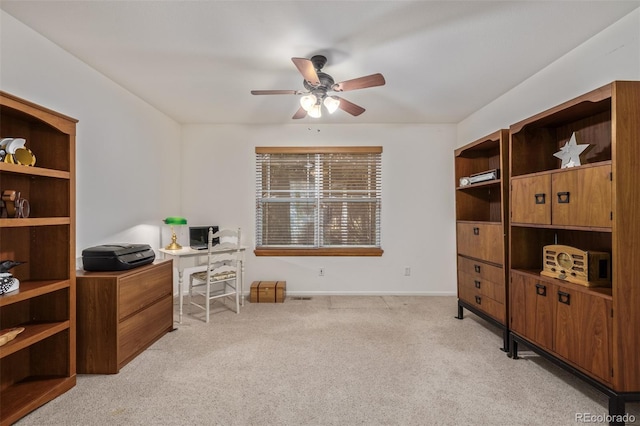 office area with light colored carpet, baseboards, and ceiling fan