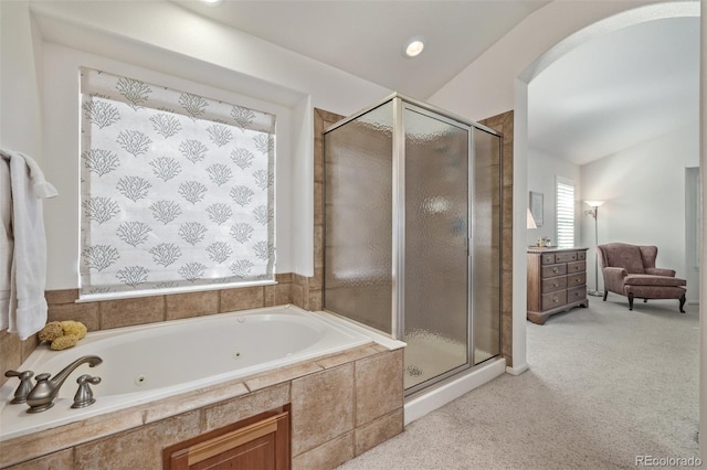 bathroom featuring a shower stall, lofted ceiling, and a whirlpool tub