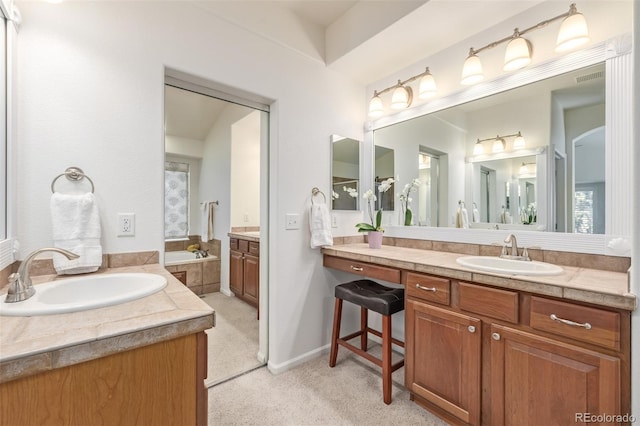 full bath with a garden tub, two vanities, baseboards, and a sink