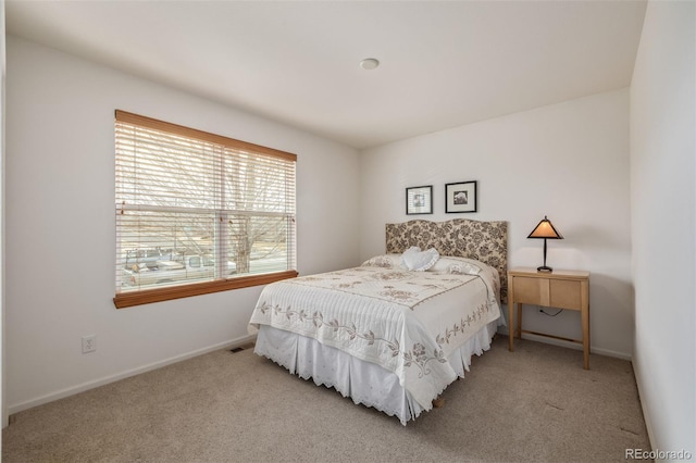 bedroom featuring baseboards and carpet floors