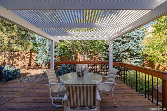 wooden terrace with outdoor dining area, a pergola, and fence