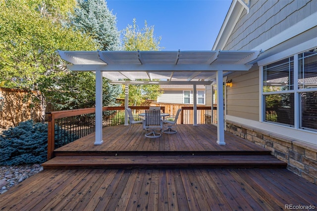 deck featuring outdoor dining space and a pergola