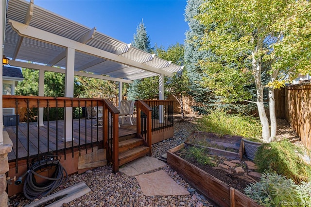 deck with a garden, a pergola, and fence