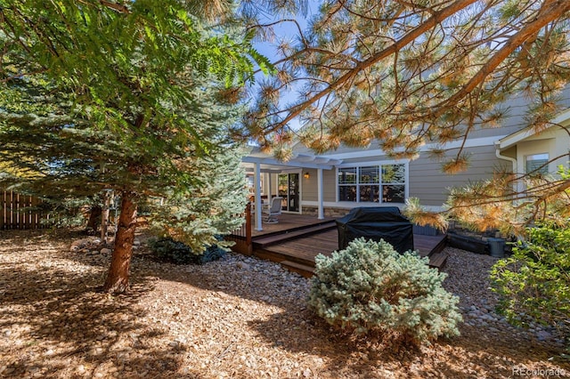 rear view of house featuring a deck and a pergola