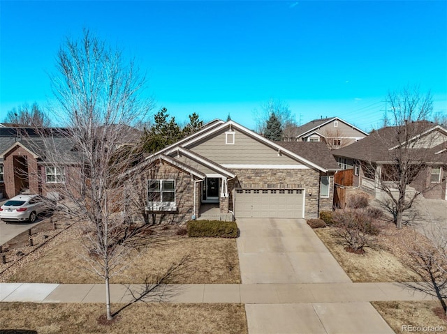 view of front facade with stone siding, an attached garage, and driveway