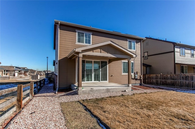 back of property featuring a patio area and a yard