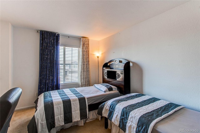 bedroom featuring light carpet