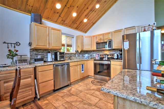 36 Gitche Goone Ln, Como, CO 80432 - kitchen with appliances with stainless steel finishes, light brown cabinetry, recessed lighting, backsplash, and high vaulted ceiling