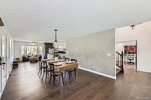dining space featuring stairs, baseboards, and dark wood finished floors