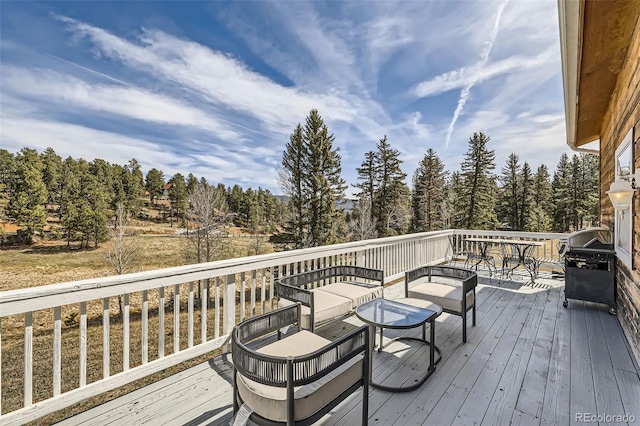 wooden terrace with an outdoor living space
