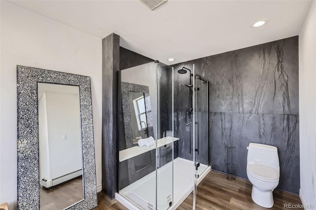 full bath with toilet, recessed lighting, wood finished floors, visible vents, and a stall shower