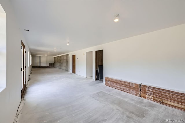 spare room featuring unfinished concrete flooring