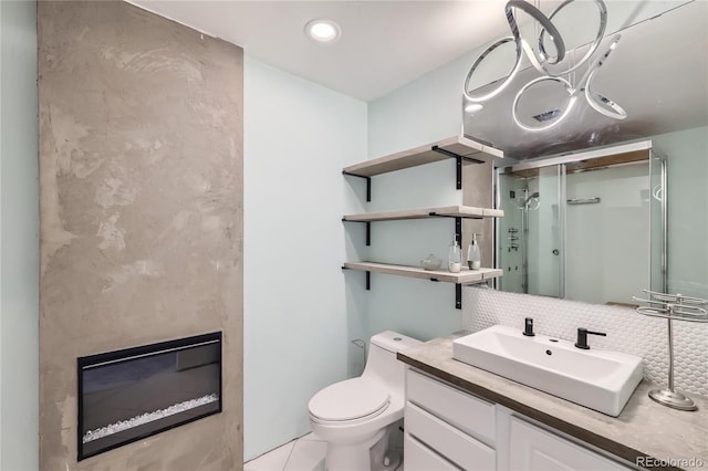 bathroom featuring vanity, toilet, recessed lighting, tasteful backsplash, and a stall shower