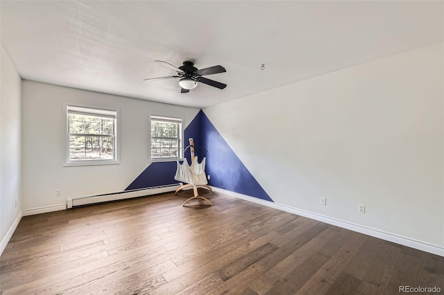 empty room featuring wood-type flooring, baseboards, a baseboard heating unit, a ceiling fan, and vaulted ceiling