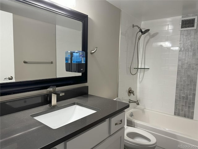 full bathroom with toilet, tiled shower / bath combo, and vanity