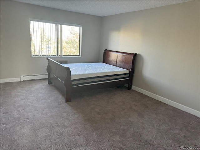 bedroom featuring a baseboard radiator, baseboards, a textured ceiling, and carpet flooring