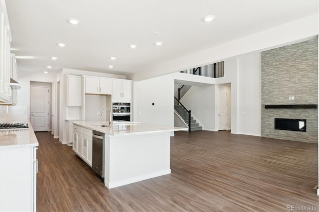 13765 Emerald Lake St, Parker, CO 80138 - kitchen featuring a sink, white cabinets, light countertops, open floor plan, and recessed lighting