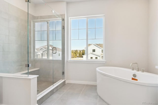 13765 Emerald Lake St, Parker, CO 80138 - full bathroom with a shower stall, tile patterned floors, a freestanding tub, and baseboards
