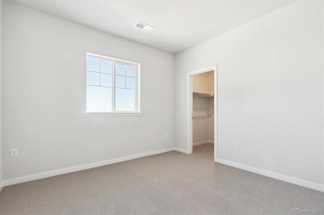 13765 Emerald Lake St, Parker, CO 80138 - unfurnished bedroom with carpet, a spacious closet, baseboards, and a closet