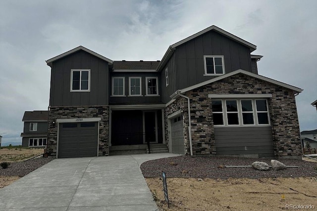 13765 Emerald Lake St, Parker, CO 80138 - view of front facade with board and batten siding, a garage, stone siding, and driveway