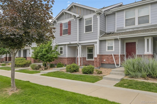5813 Ceylon St, Denver, CO 80249 - multi unit property featuring brick siding, board and batten siding, and a front yard