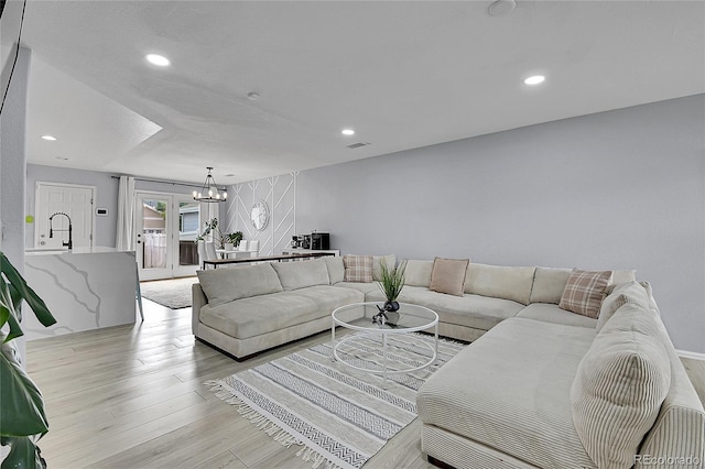 5813 Ceylon St, Denver, CO 80249 - living room with a chandelier, light wood-style flooring, and recessed lighting