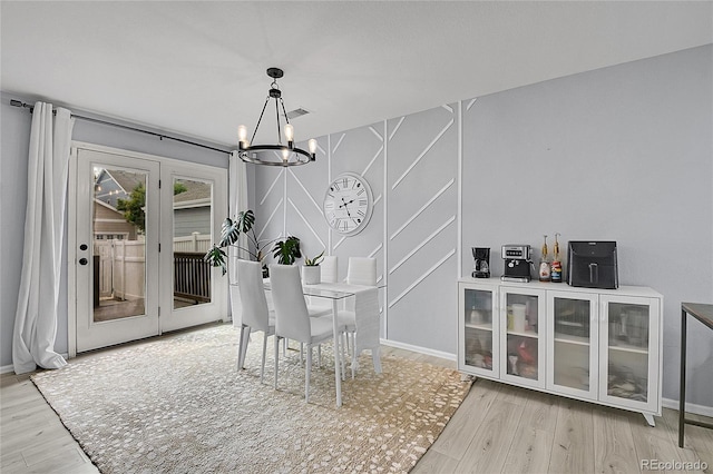 5813 Ceylon St, Denver, CO 80249 - unfurnished dining area with a chandelier and wood finished floors
