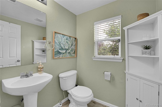 5813 Ceylon St, Denver, CO 80249 - half bath featuring baseboards and toilet
