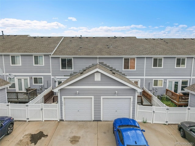 5813 Ceylon St, Denver, CO 80249 - view of front facade featuring a gate, driveway, an attached garage, and a fenced backyard