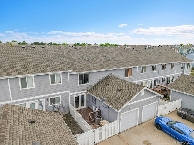 5813 Ceylon St, Denver, CO 80249 - rear view of house featuring a gate, roof with shingles, a residential view, and concrete driveway